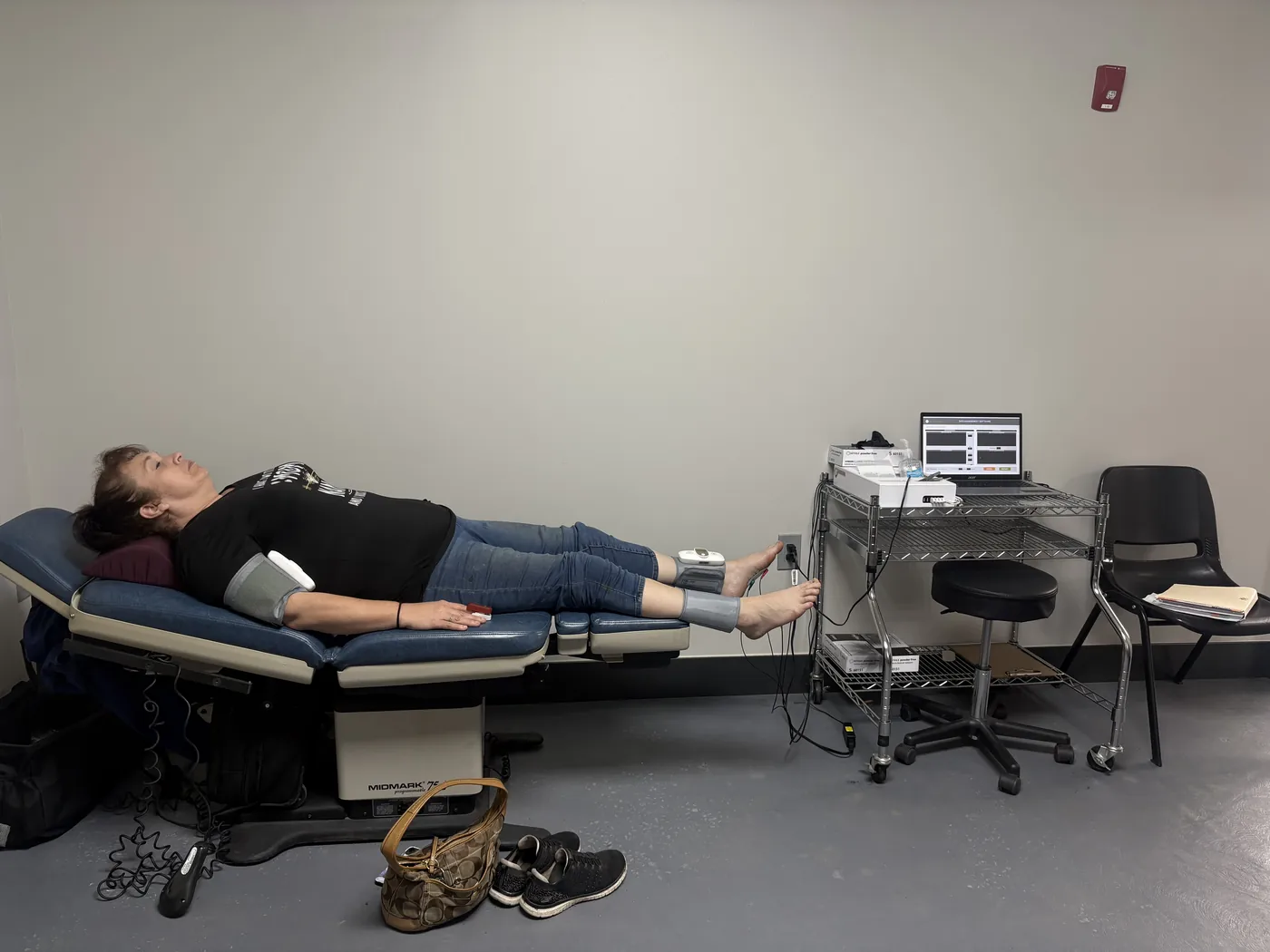 Ankle-brachial index cuffs fitted to both ankles with plantar surface electrodes on the soles for combined circulation and nerve testing of the feet at Padda Institute, St. Louis